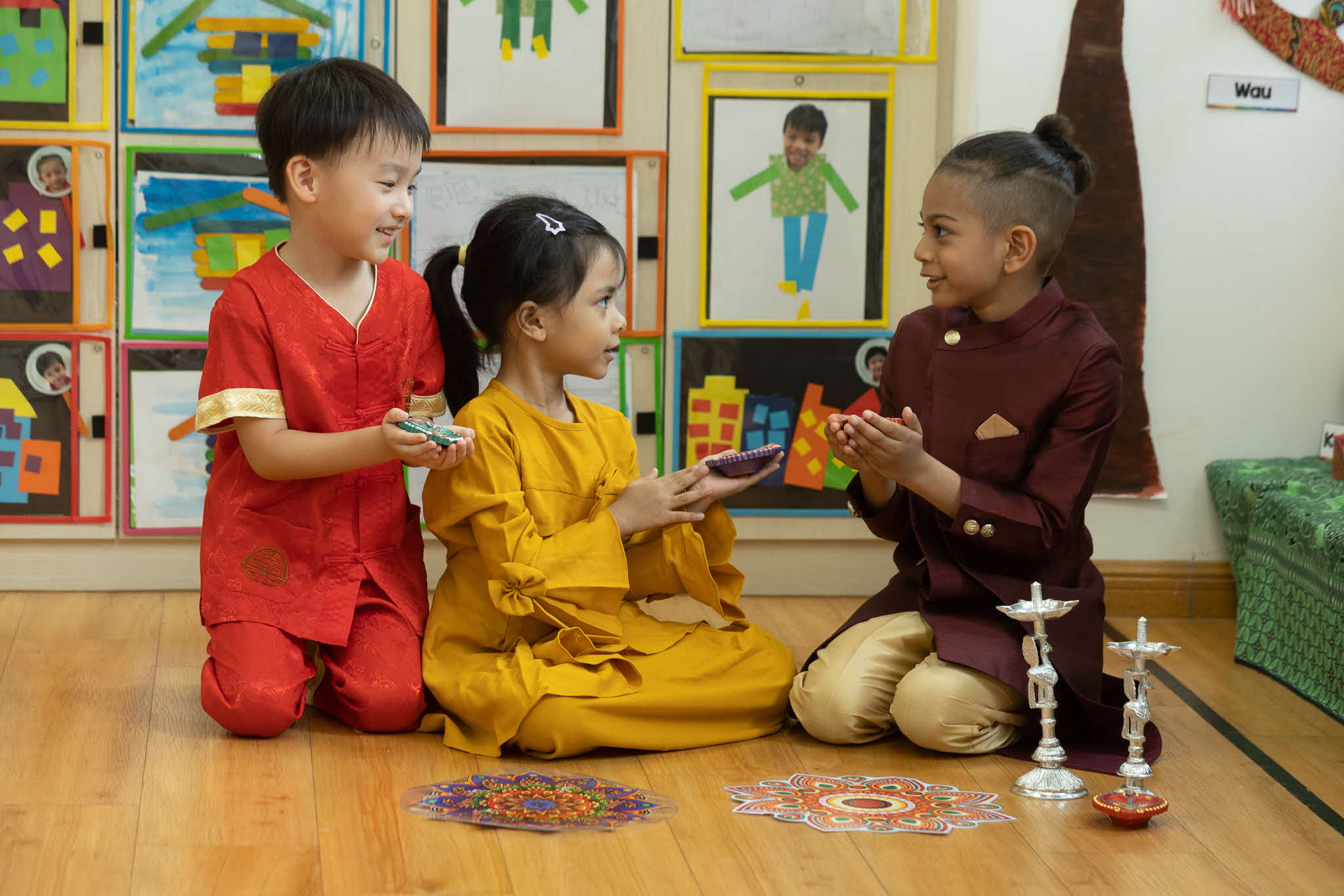 children of different races all learning about deepavali